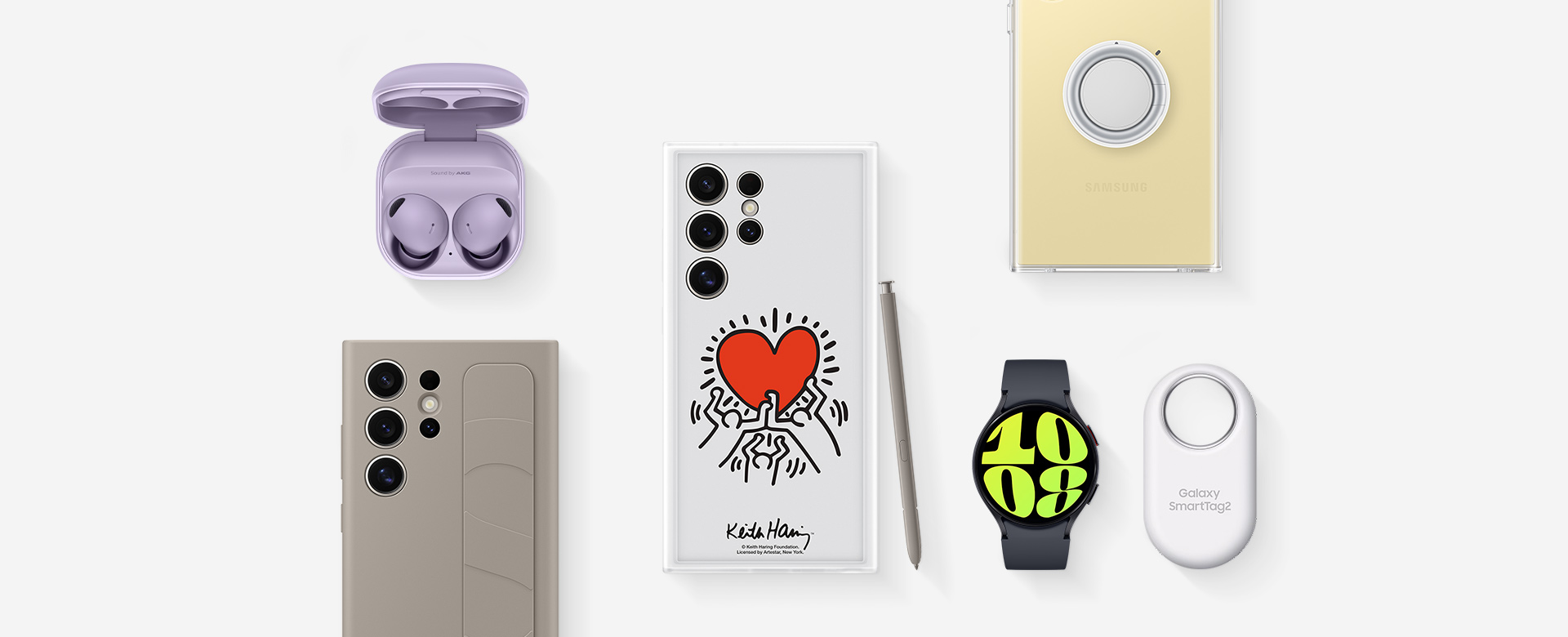 Un diseño plano de accesorios para Galaxy S24 Ultra: Galaxy Buds2 Pro en Bora Purple con la base abierta y los auriculares colocados, Galaxy S24 Ultra con la carcasa de agarre vertical en Taupe instalada, galaxy S24 Ultra con la carcasa Flipsuit en White instalada y el S Pen integrado apoyado en el lateral,  Galaxy S24 Ultra con la carcasa de dispositivo transparente instalada, Galaxy Watch6 en Graphite y el Galaxy SmartTag2 en White.