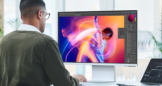 A man editing an image on the monitor.