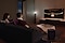 A couple enjoys a movie night in their living room with Samsung Soundbar's theater-like surround sound.
