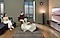 A couple is immersed in the soothing sounds of a nature scene as they watch TV in their apartment.
