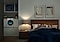 It’s night time. The couple is sleeping in their bedroom while the QuickDrive™ is washing close in the next room. The lights on the QuickDrive™ are on and the machine is running smoothly and quietly so they can sleep peacefully.