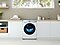 The QuickDrive™ washing machine is perfectly built into a laundry room. The washing machine looks sleek and refined, running smoothly and quietly.