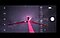 A bright red wind power generator stretching up into the sky against some Milky Way with on-screen camera controls demonstrating how shutter speed works.