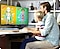 The father and the child are learning while looking at the monitor.