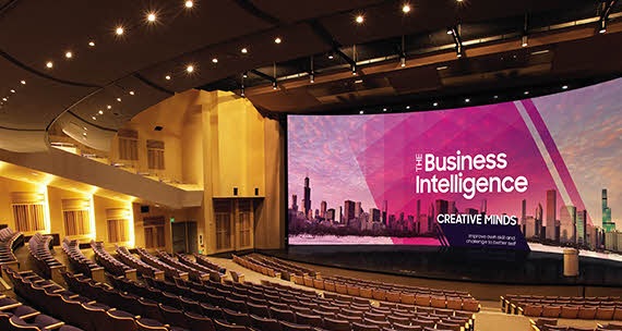 Inside a theater with a large screen