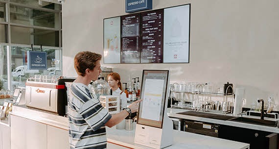 At the store, Nam Seol is placing an order using a kiosk.