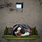Retrato de amor aéreo de una pareja acurrucada en un sofá en el desierto mirando una película