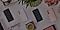 4 samsung galaxy S22 phones in phantom white, phantom black, green and pink gold colours faced down on a table