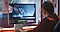 A woman editing a video on the monitor.