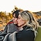 Romantic photo taken from the side showing a couple under a blanket in the desert