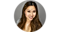 Headshot of Thao Hyunh against a gray background. She's wearing a blouse and necklace and smiling