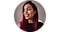 Headshot of Krystal Lora against a gray background. She's wearing a crop top and looking to her right while smiling.