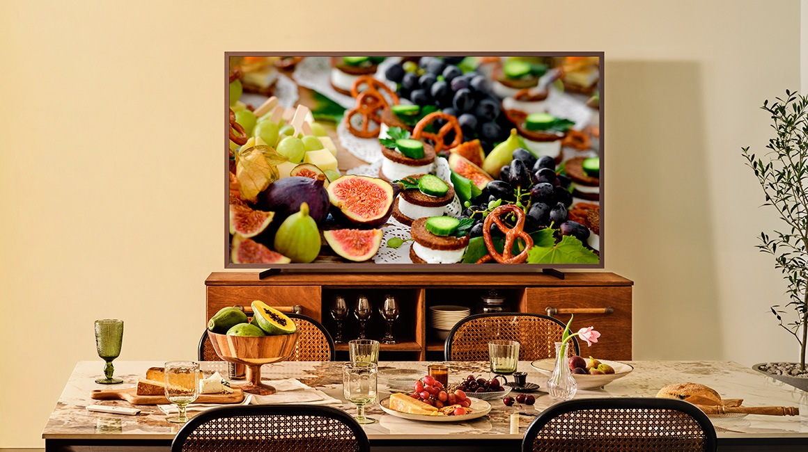 A 98 inch Supersize TV is placed in the living room area displaying a sail boat.