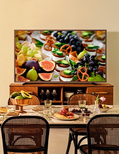 A 98 inch Supersize TV is placed in the living room area displaying a sail boat.
