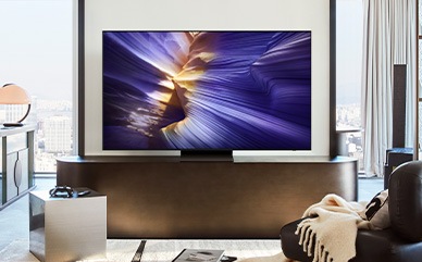 A 98 inch Supersize TV is mounted on a wall in a living room displaying water.