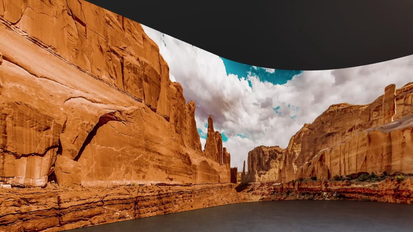 After passing through the dark tunnel, you  can see the valley and zoom out and the  curved screen of The Wall appears. "The  Wall, Make a bold statement" appears.