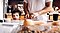 Child peers over counter while man preps food