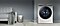 A smart washing machine on the right hand side and a sofa, laundry basket, and some laundry that needs to be washed are on the left hand side.