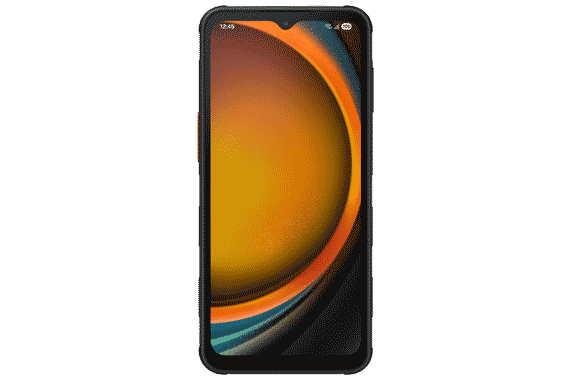 The ruggedized Galaxy XCover7 smartphone standing with the screen facing the camera in front of a half-built concrete room.