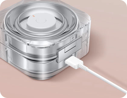 USB-C cable connected to a transparent Galaxy Ring charging case.