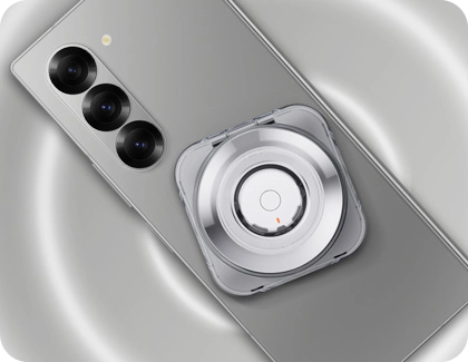 Galaxy Ring charging case placed on the back of a Galaxy phone, using Wireless PowerShare technology.