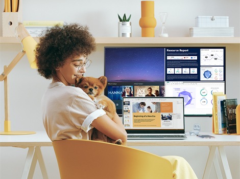 A girl hugging a dog while taking a break from work.