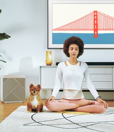 A girl meditating with a dog next to her.