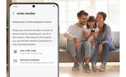 A Galaxy phone is displaying a SmartThings screen next to a family sitting on a couch and looking at the phone