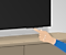 A graphic illustration of someone pressing the TV controller button allowing people to access the menu of a Samsung TV