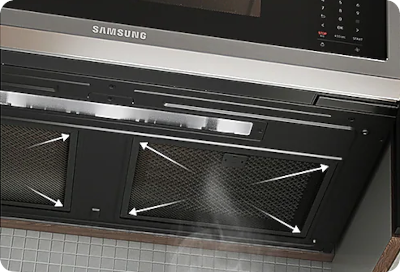 Arrows pointing to grease filters under a Samsung over-the-range microwave.