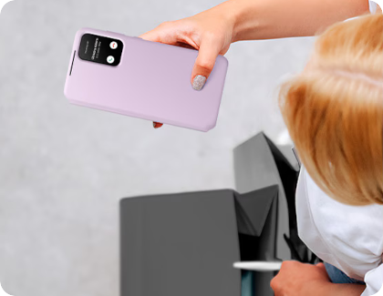 A woman holding a Galaxy phone with a cover that shields the screen.