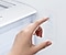 Hand adjusting the temperature settings on a Samsung refrigerator control panel.