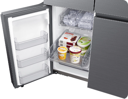 Opened freezer drawer with ice cream containers and frozen treats inside a Samsung refrigerator.