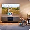 In a living room, a Samsung Smart TV plays content after automatically detecting the dog's barking sounds via Pet Care.