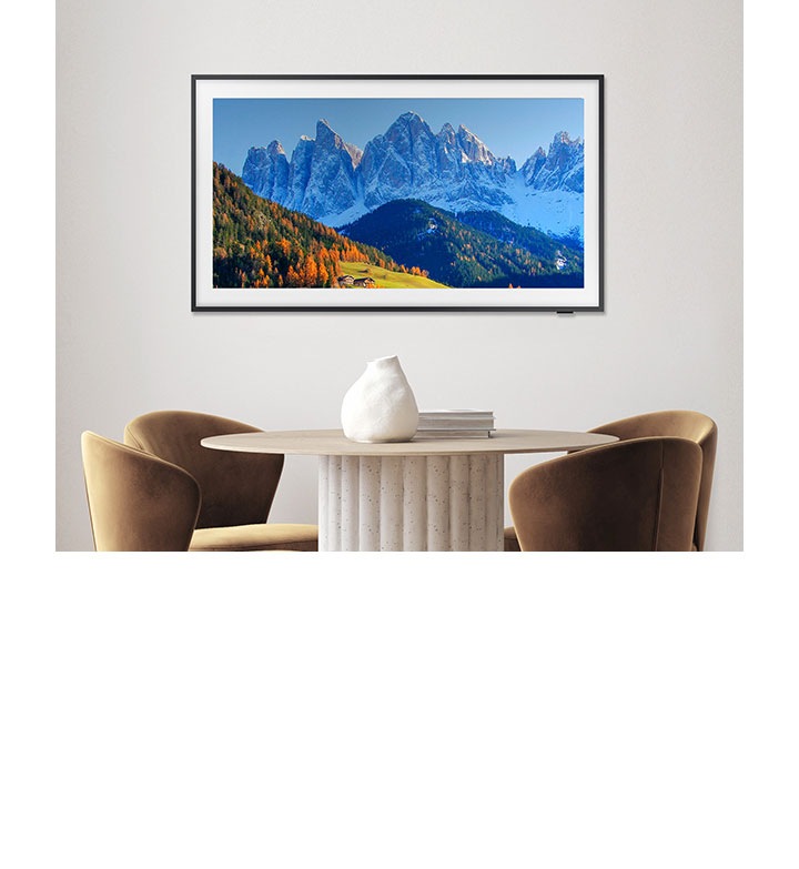 A Samsung TV is mounted on the wall displaying mountains.