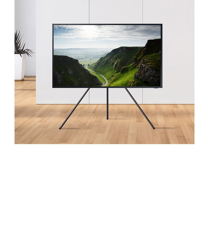 A Samsung TV is free-standing on its own, mounted on a tripod.