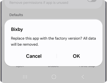Confirmation prompt on a Samsung Galaxy phone asking to replace the app with the factory version, with Cancel and OK options.