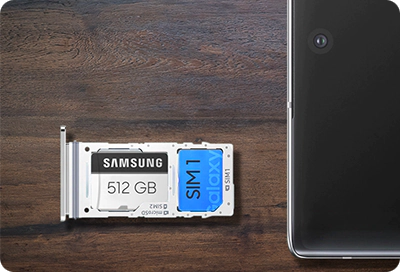 microSD card and SIM card in a shared tray next to a Samsung Galaxy phone.
