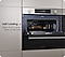 A Dual Cook Flex is placed between metal colored cabinets. Its door opens to reveal a large chicken and veggies on a large tray, indicating the ability to cook a large meal. Next, only the top compartment opens to reveal another dish, indicating cooking flexibility that also saves 25.3% energy and 22.7% time with Half Loading.