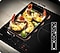 A close-up of the Flex Zone Plus with 3 icons indicates that different types of cookware can be used. An empty glass casserole on the cooktop is filled with shrimp and lime.