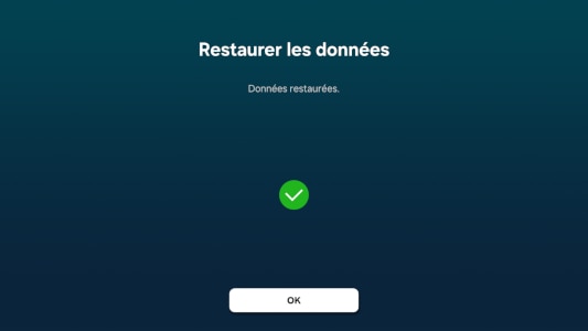 Écran de confirmation indiquant 'Données restaurées' avec une icône de coche verte et un bouton 'OK'.