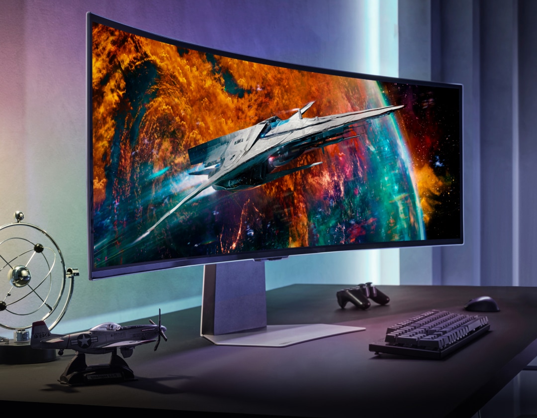 The Odyssey OLED is on a desk with a keyboard, controller, mouse a model airplane and a gyroscope toy. The monitor shows a spaceship flying over a colorful planet. Above the monitor is a badge for the CES Innovation awards, naming the Odyssey OLED as a 2023 honoree.