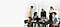 In einem Büro haben fünf Personen in legerer Business-Kleidung ein Meeting an einem Tisch mit Notizbüchern, Klemmbrettern und Galaxy Books. Durch das Fenster des Büros ist eine Stadtlandschaft zu sehen.