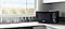 Black Samsung freestanding microwave on modern kitchen work surface.