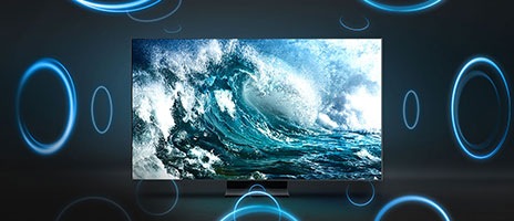 Auf dem Fernseher wird eine Nahaufnahme von kräftigen, brechenden Wellen gezeigt. Blaue Kreise um den Fernseher herum veranschaulichen den satten und beeindruckenden Klang.