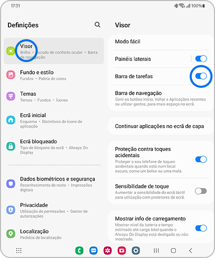 Vista do ecrã “Definições” e “Visor” com as opções “Visor” e o botão de alternar “Barra de tarefas” realçados.