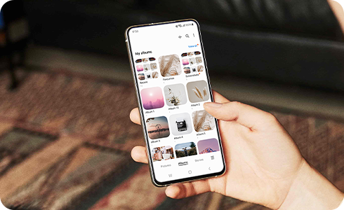 View of person holding a galaxy device to view albums.