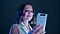 Millie Bobby Brown smiles as she looks at a ghost white Galaxy A80 in her hand