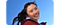 An individual wearing a red jacket is smiling