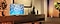 Salon avec le meuble TV et la TV avec une ambiance orangé